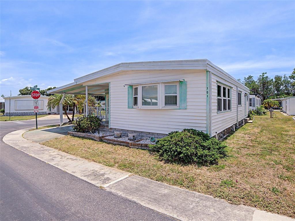 701 Sugar Palm Street Largo, FL 33770 - Photo 3 of 35 a front view of a house with a yard