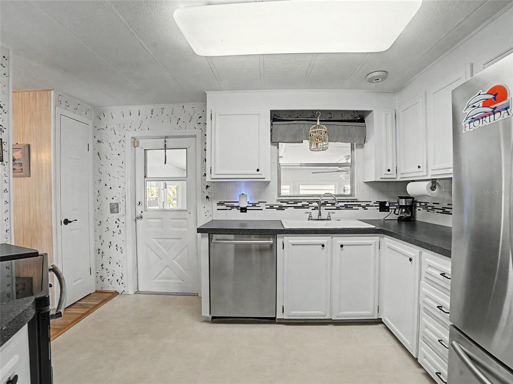 701 Sugar Palm Street Largo, FL 33770 - Photo 7 of 35 a kitchen with a sink stove and refrigerator