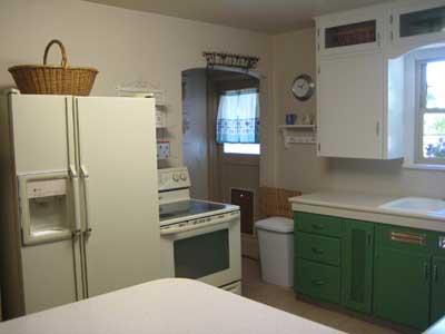 1360 Dilley Road Tieton, WA 98947 - Photo 4 of 23 a kitchen with a refrigerator a stove a washer and dryer