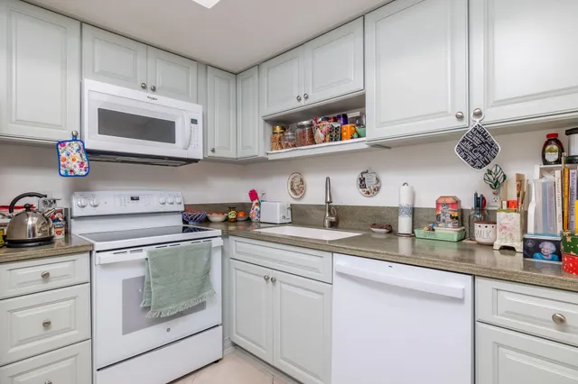 a kitchen with cabinets and window