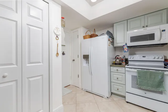 a kitchen with stainless steel appliances white cabinets and a sink