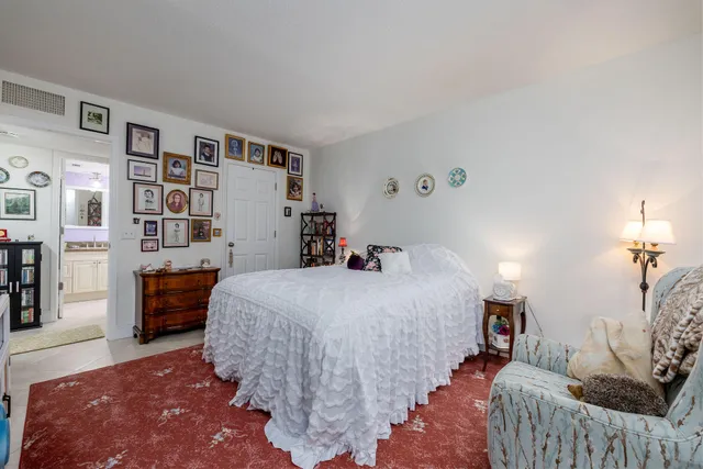 a bedroom with a bed and a book shelf