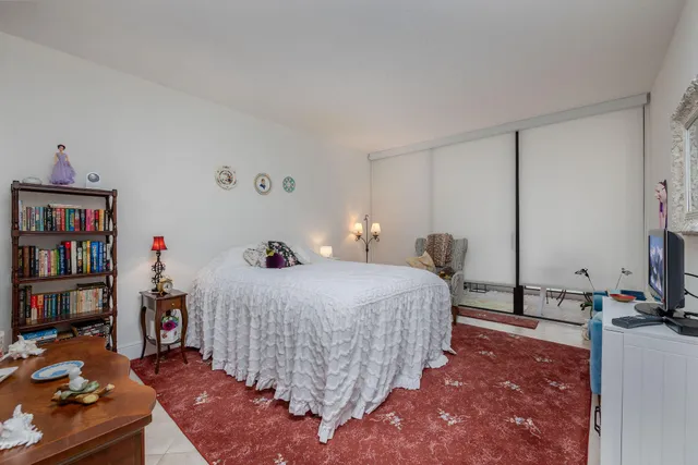 a bathroom with a granite countertop toilet sink and mirror