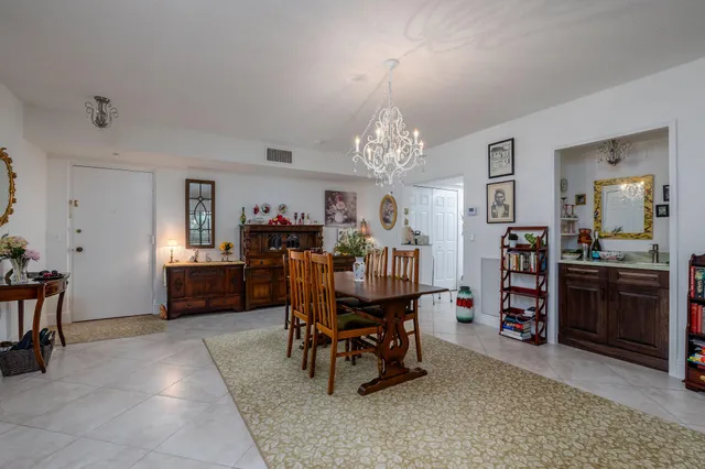 a view of a dining room with furniture and chandelier