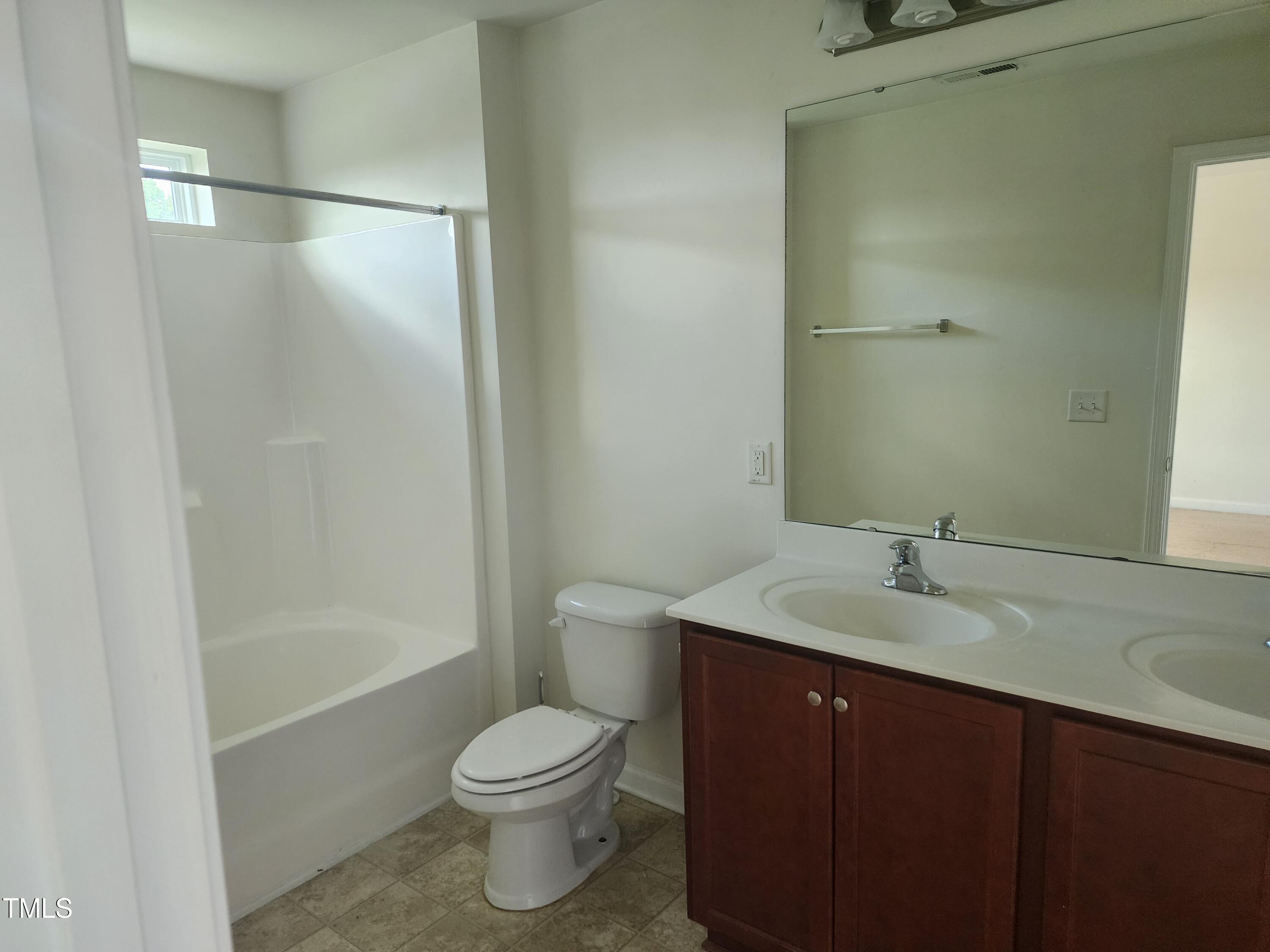 1304-107 Cozart Street, Unit 107 Durham, NC 27704 - Photo 12 of 15 a bathroom with a granite countertop sink toilet and shower