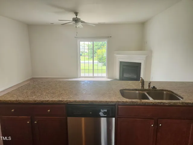 a kitchen with granite countertop a sink and a window