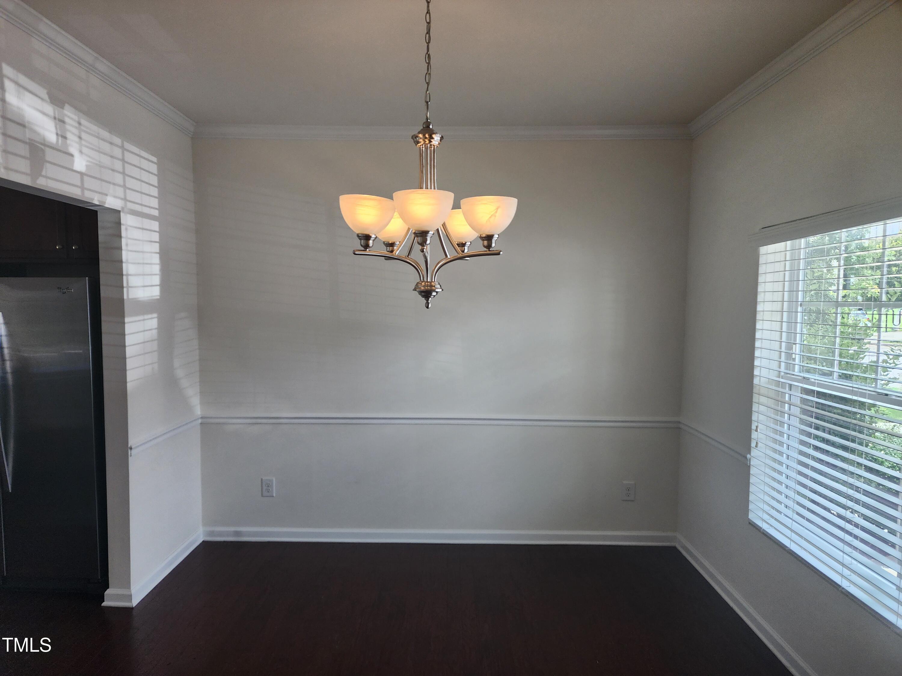 1304-107 Cozart Street, Unit 107 Durham, NC 27704 - Photo 6 of 15 a view of a room with wooden floor cabinets and a chandelier