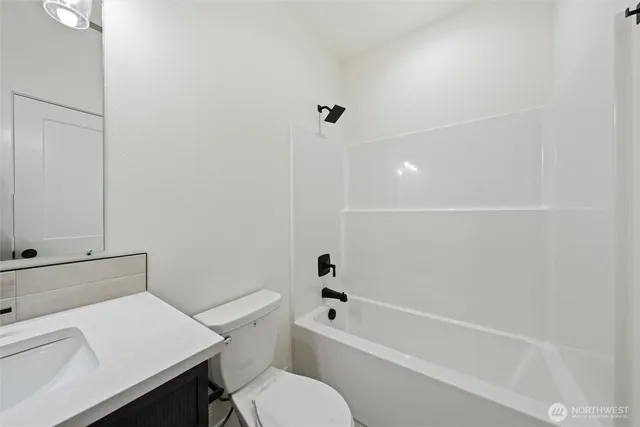a white toilet sitting next to a bath tub