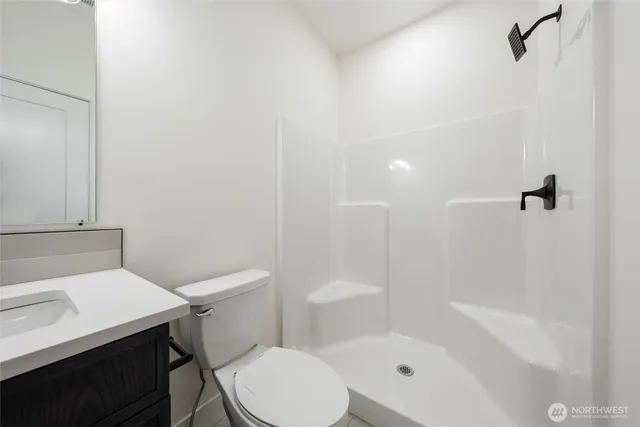 a white toilet sitting next to a bath tub
