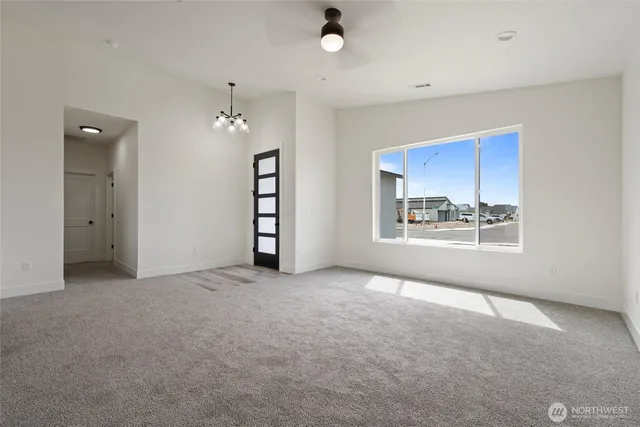 an empty room with windows and cabinet