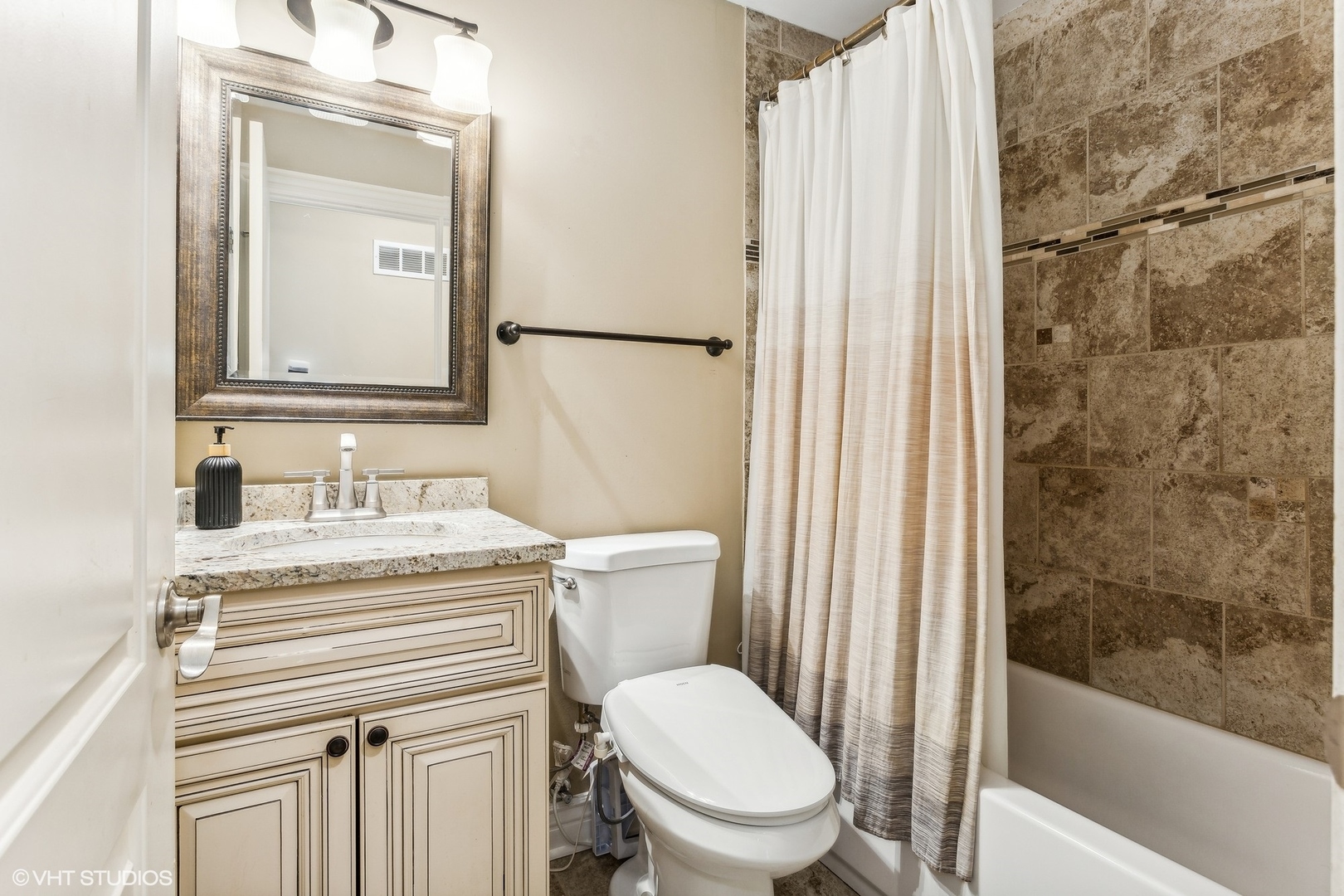9001 East Prairie Road Evanston, IL 60203 - Photo 12 of 19 a bathroom with a granite countertop sink toilet a mirror and shower
