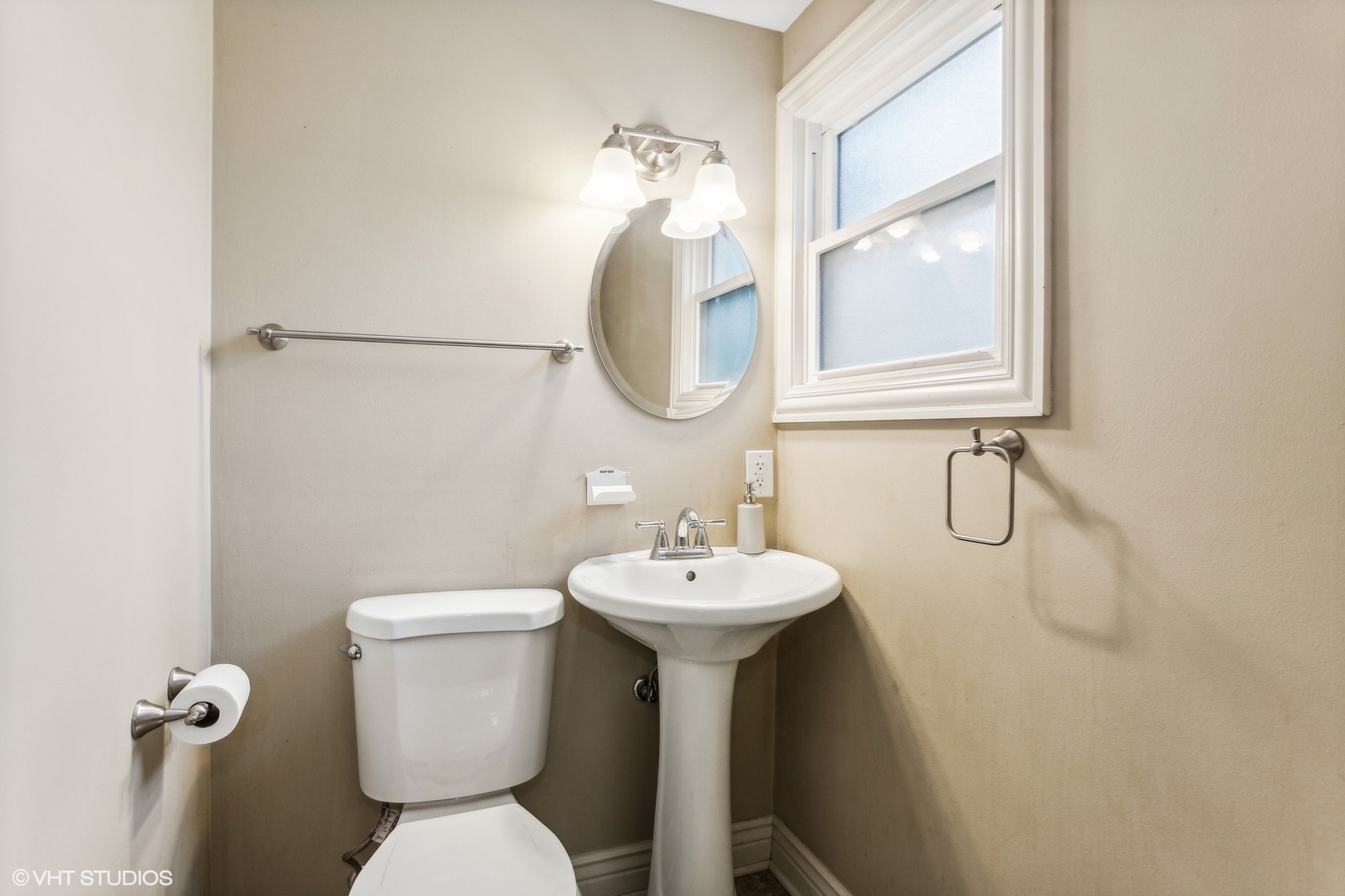 9001 East Prairie Road Evanston, IL 60203 - Photo 16 of 19 a bathroom with a sink mirror toilet and a window