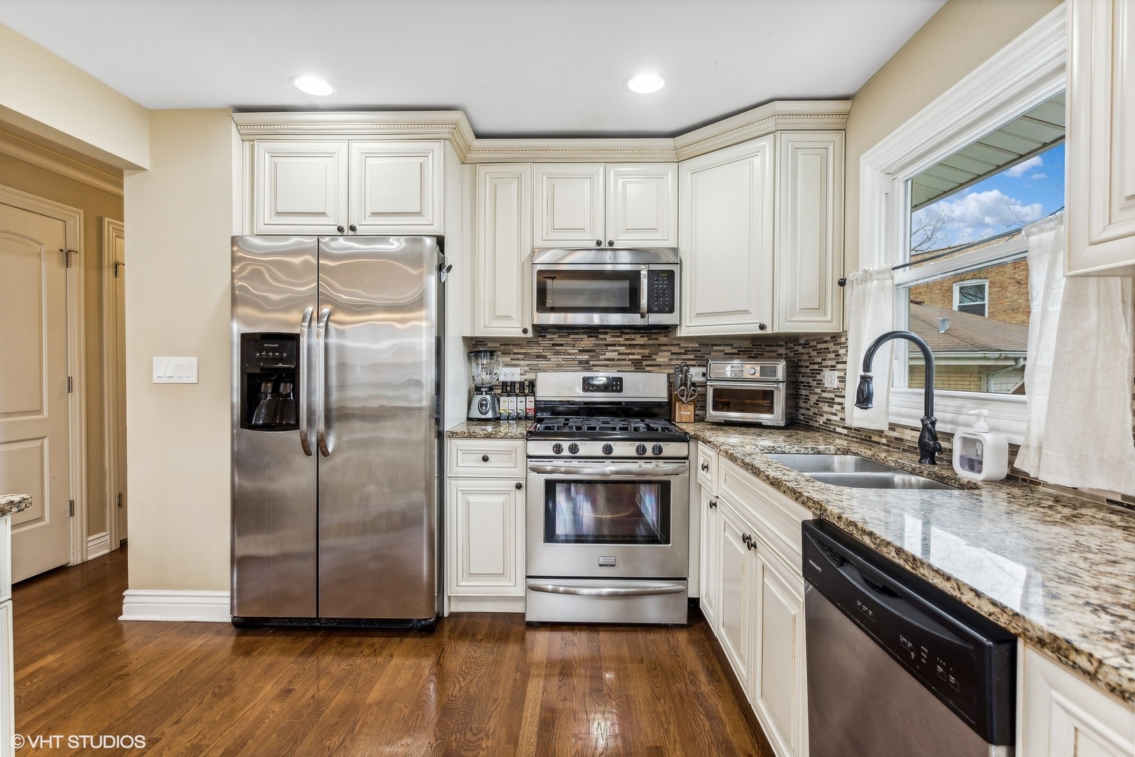 9001 East Prairie Road Evanston, IL 60203 - Photo 5 of 19 a kitchen with granite countertop a refrigerator stove and sink
