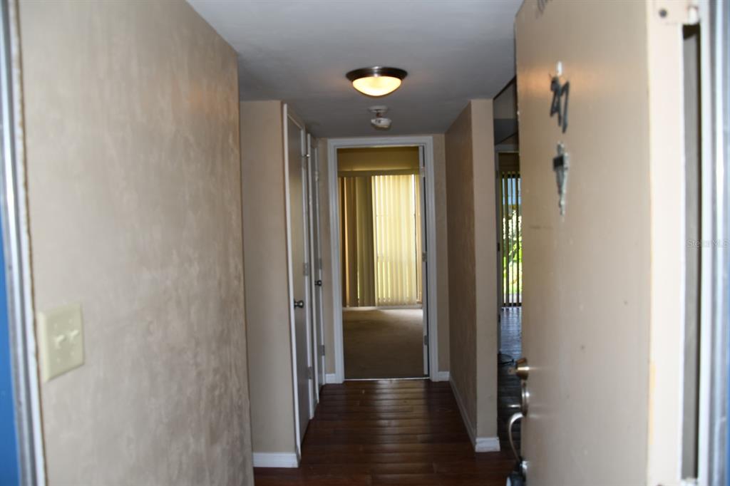 2811 Southwest Archer Road, Unit Y217 Gainesville, FL 32608 - Photo 4 of 8 a view of a hallway with wooden floor and a bathroom