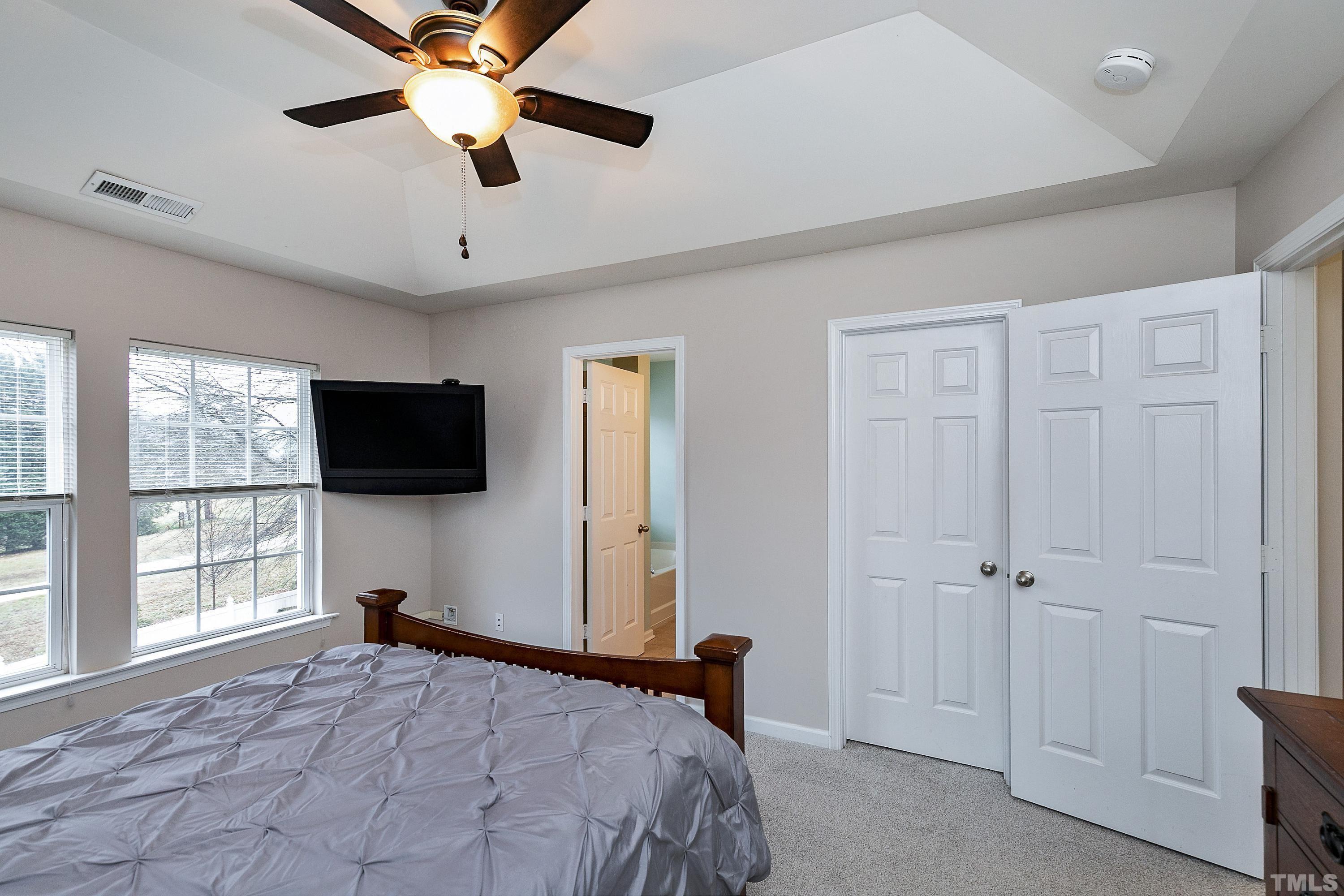 160 Solheim Lane Raleigh, NC 27603 - Photo 17 of 33 a bedroom with a bed and a flat screen tv