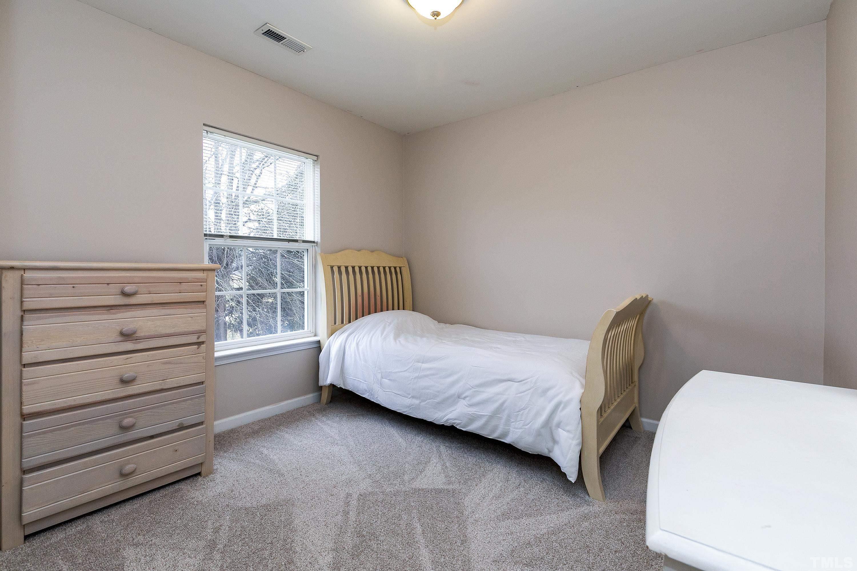 160 Solheim Lane Raleigh, NC 27603 - Photo 23 of 33 a bedroom with a bed and a window