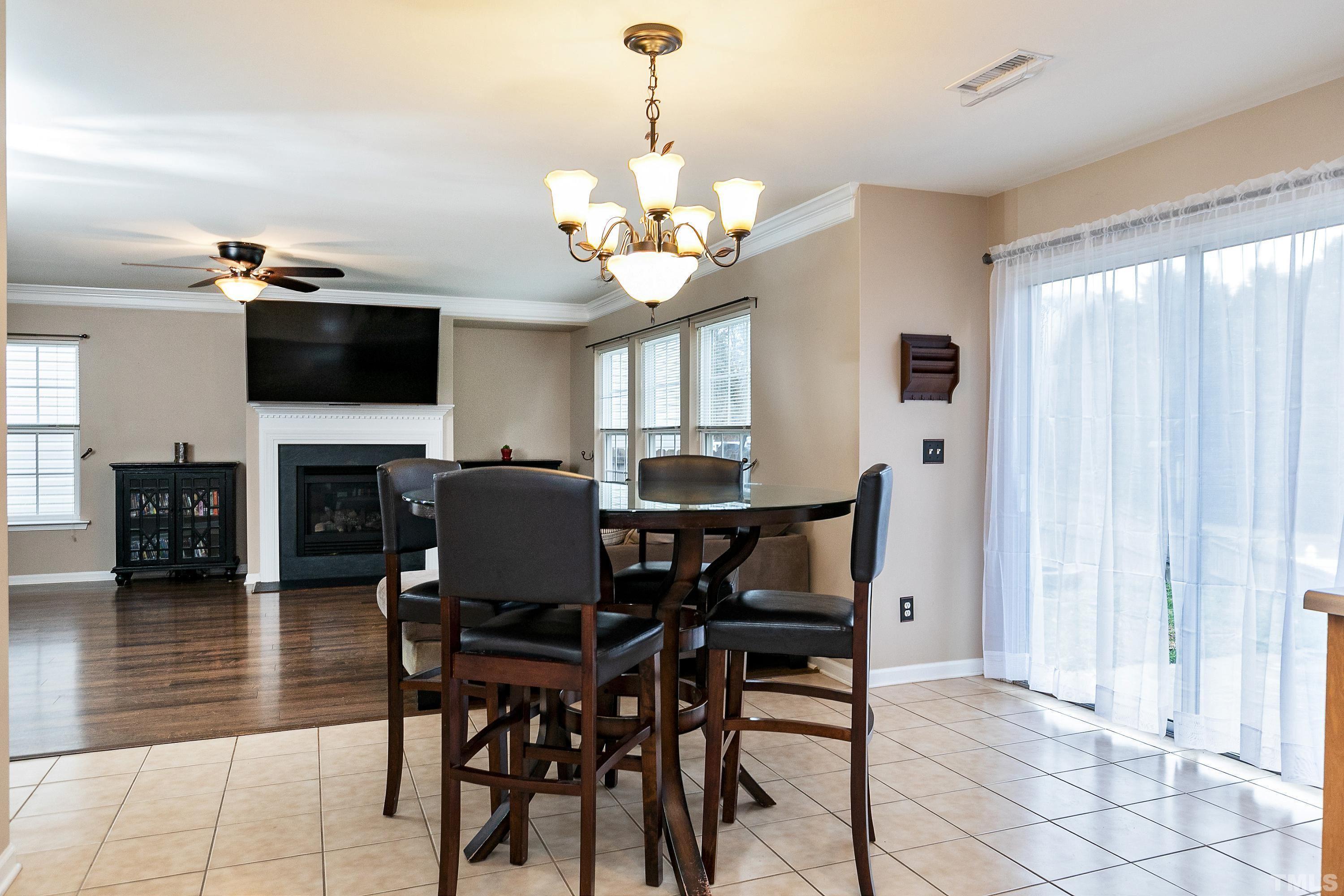 160 Solheim Lane Raleigh, NC 27603 - Photo 4 of 33 a view of a dining room with furniture and a chandelier