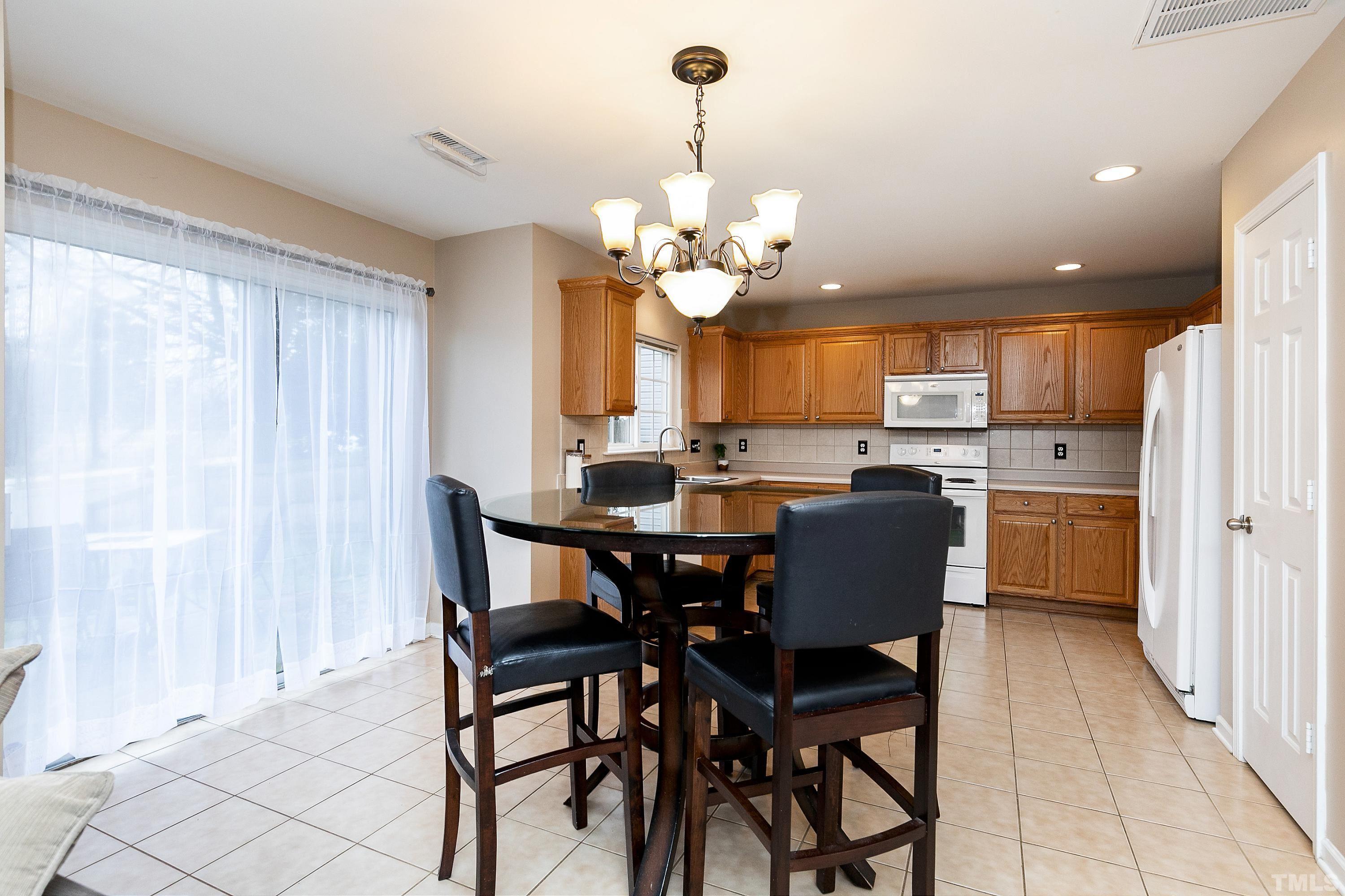 160 Solheim Lane Raleigh, NC 27603 - Photo 5 of 33 a dining room filled with furniture and window
