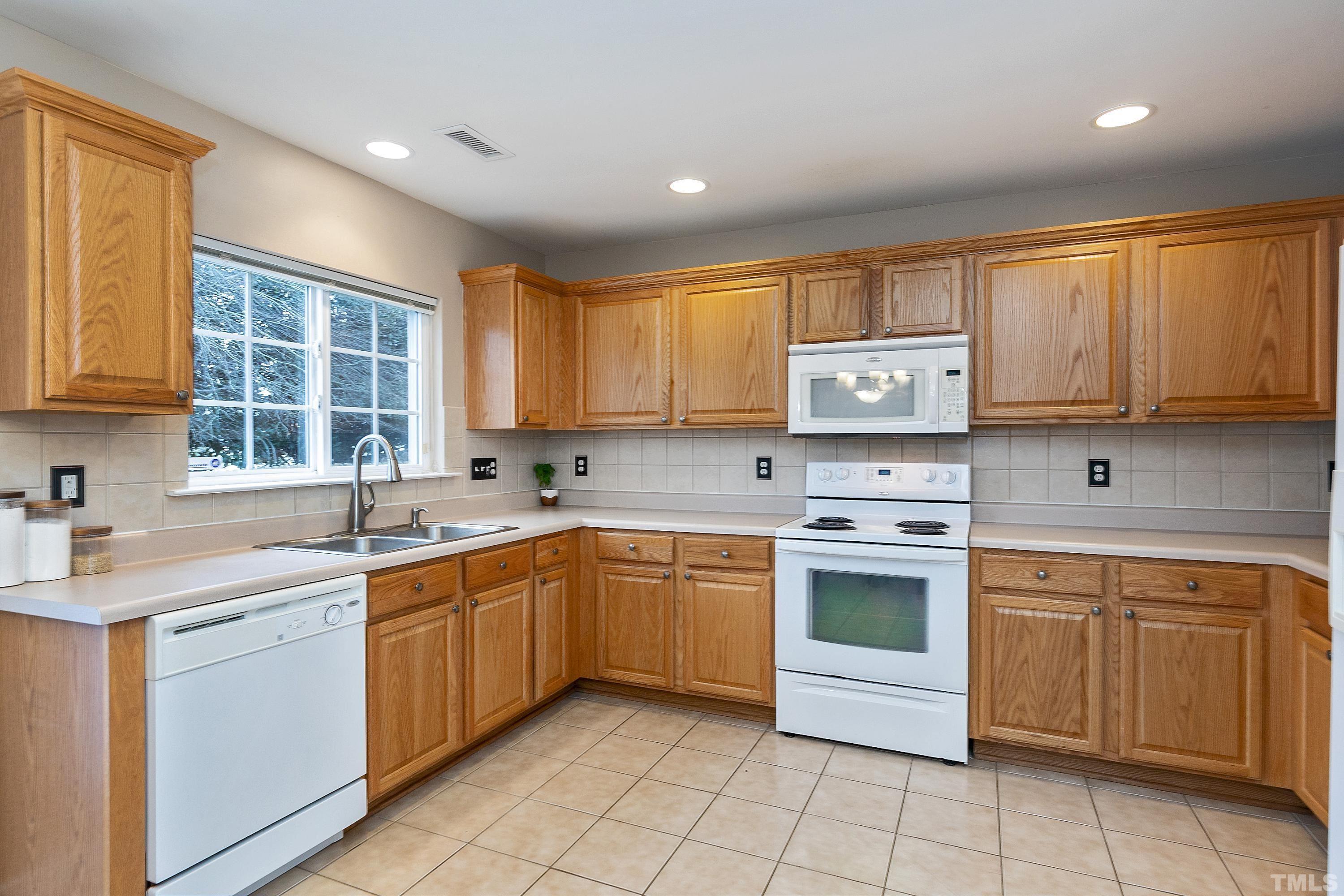 160 Solheim Lane Raleigh, NC 27603 - Photo 9 of 33 a kitchen with a stove sink and cabinets