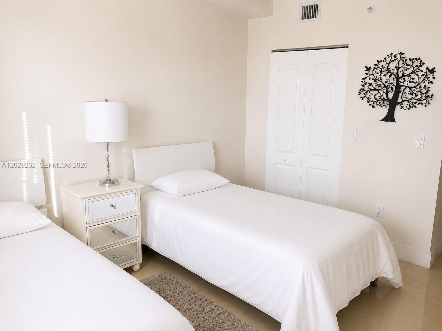 17100 North Bay Road, Unit 1605 Sunny Isles Beach, FL 33160 - Photo 17 of 52 a large white bed in a white room
