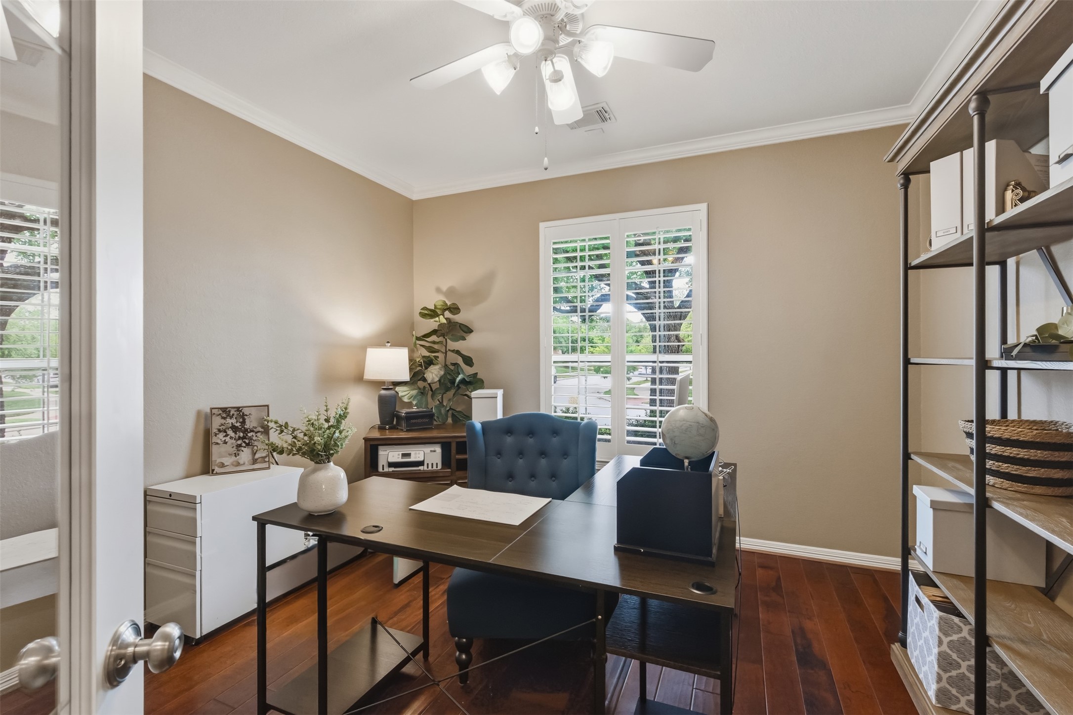 20722 Windrose Bend Drive Spring, TX 77379 - Photo 9 of 50 This elegant home office offers privacy and sophistication with its plantation shutters, crown molding, and French doors, creating a truly inspiring workspace.