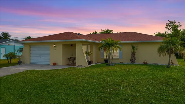 a front view of a house with a garden and yard