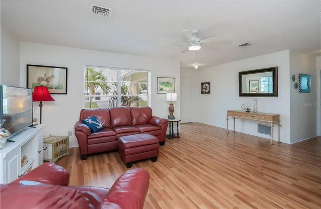 a living room with furniture and wooden floor