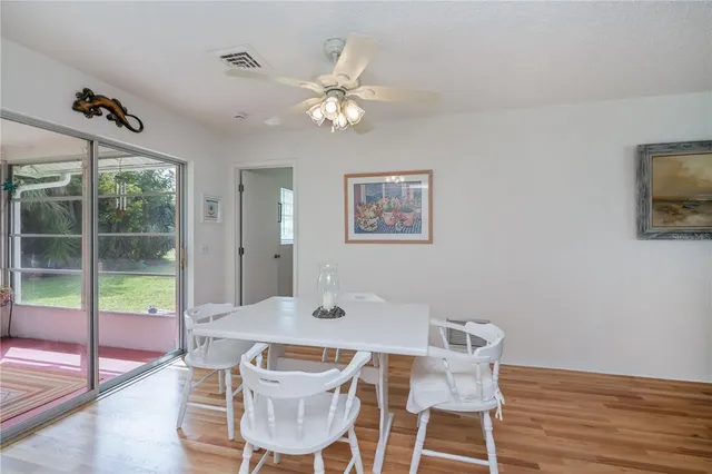 a view of a dining room with furniture and a chandelier
