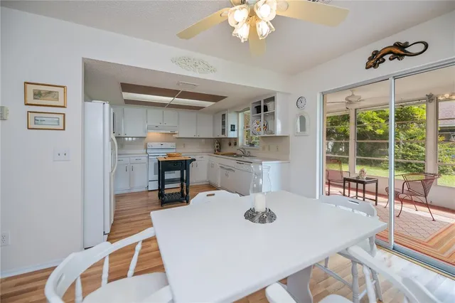 a kitchen with a sink a window and cabinets
