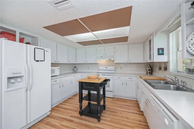 a kitchen with a sink cabinets and window