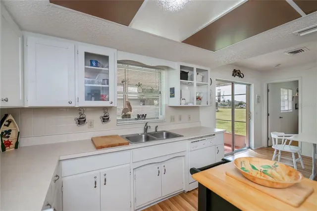 a view of a kitchen with cabinets and wooden floor