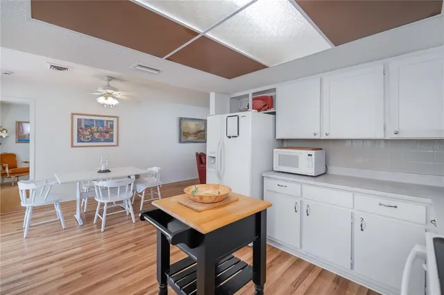 a spacious bedroom with a bed and a chandelier