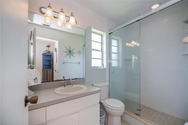 a bathroom with a granite countertop sink a large mirror and a window