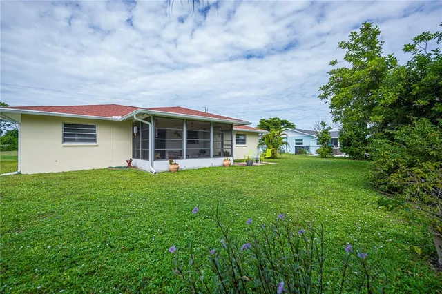 an aerial view of a house with swimming pool garden and patio