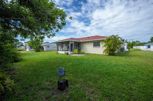 a front view of a house with a garden and yard