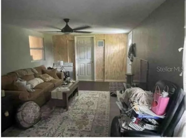 a living room with furniture and a chandelier