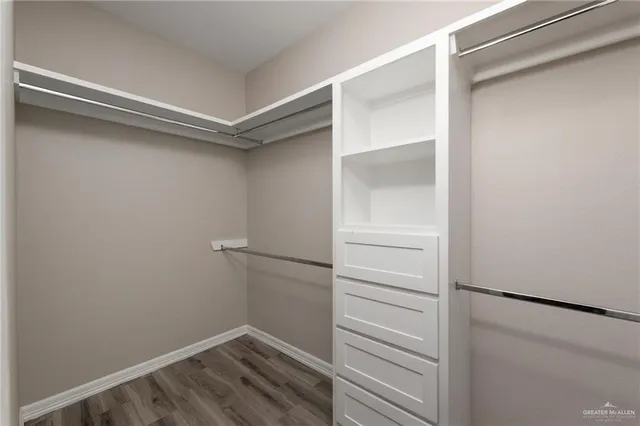 a view of walk in closet with empty racks