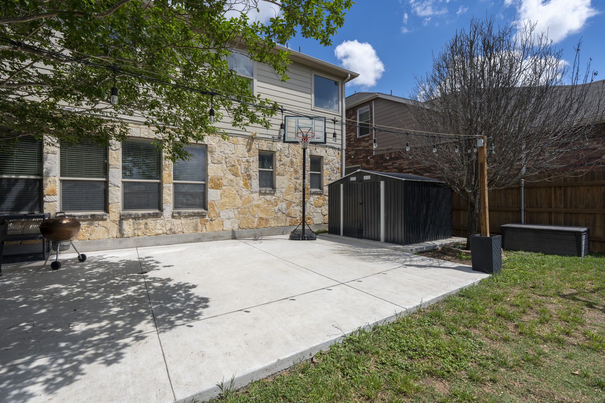 227 Sandstone Trail Buda, TX 78610 - Photo 27 of 33 Expansive concrete patio area offering ample space for outdoor activities