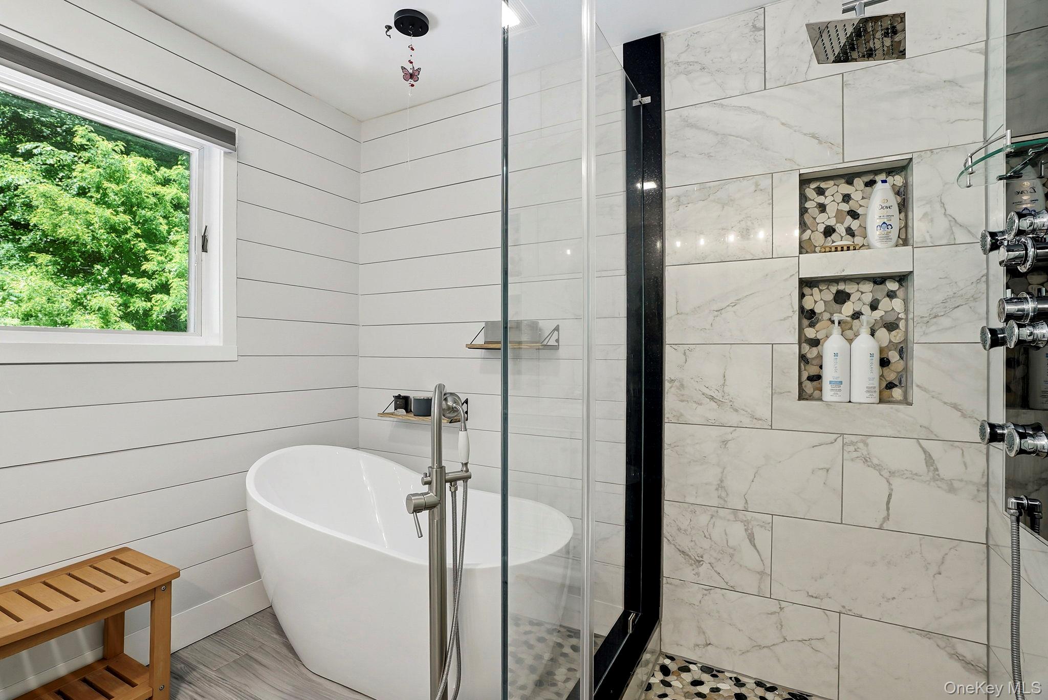 31 Ridge Road Cortlandt Manor, NY 10567 - Photo 30 of 39 Enjoy a soaking tub, glass surround shower with a pebble floor and luxurious body sprays.