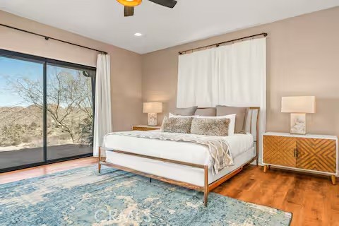 62398 Lilley Road Joshua Tree, CA 92252 - Photo 19 of 70 a spacious bedroom with a bed and window