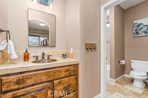 62398 Lilley Road Joshua Tree, CA 92252 - Photo 34 of 70 a bathroom with a granite countertop sink mirror and toilet