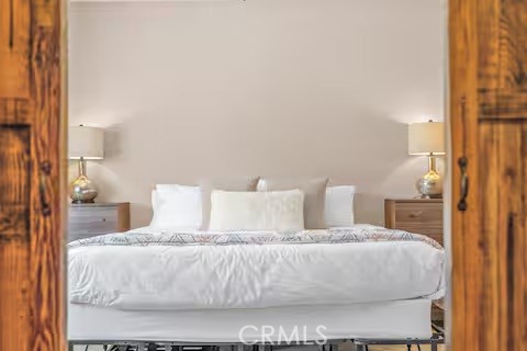 62398 Lilley Road Joshua Tree, CA 92252 - Photo 45 of 70 a large bed sitting in a bedroom next to a lamp