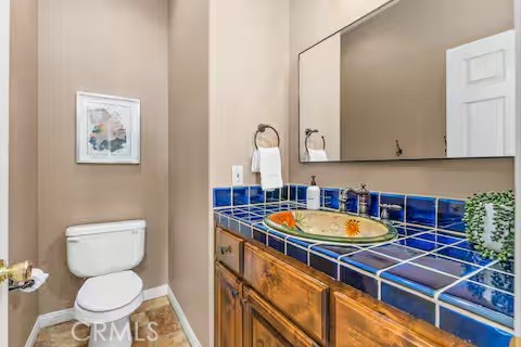 62398 Lilley Road Joshua Tree, CA 92252 - Photo 49 of 70 a bathroom with a toilet a sink and a mirror