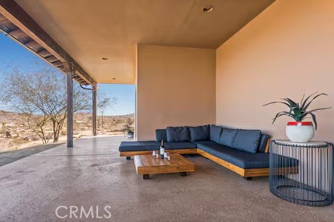 62398 Lilley Road Joshua Tree, CA 92252 - Photo 66 of 70 a living room with furniture and a floor to ceiling window