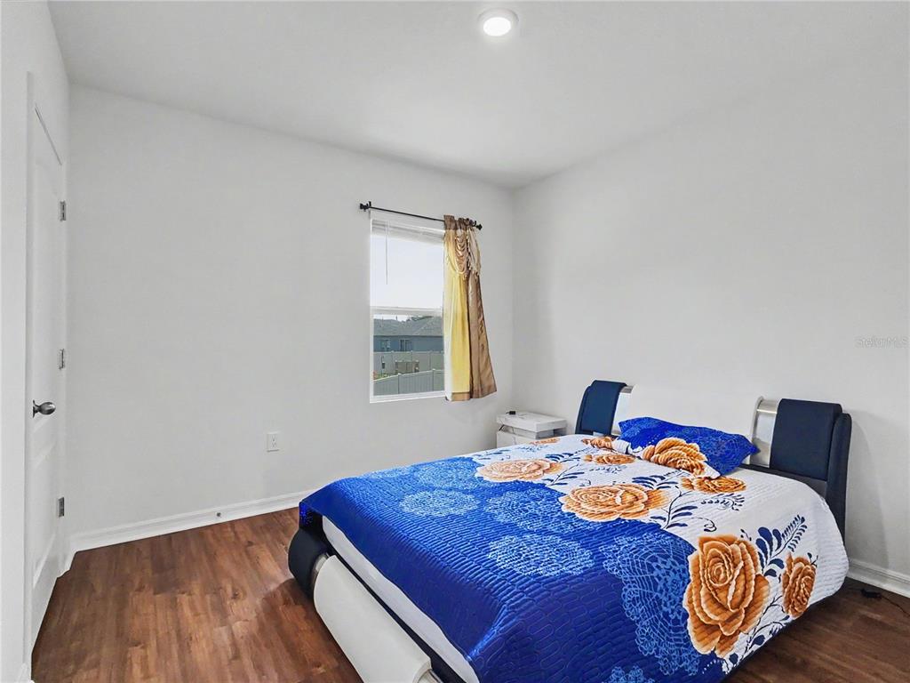 2085 Doe Run Drive Davenport, FL 33837 - Photo 33 of 44 a bedroom with a bed and a window