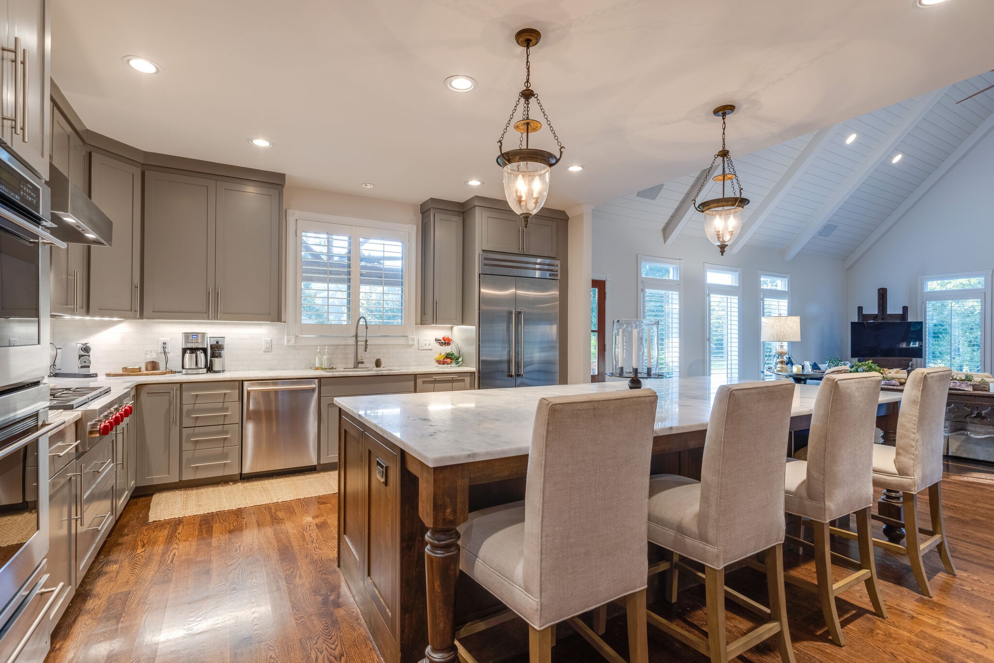 3151 McMillan Road Franklin, TN 37064 - Photo 21 of 46 a kitchen with kitchen island granite countertop a table chairs sink and cabinets