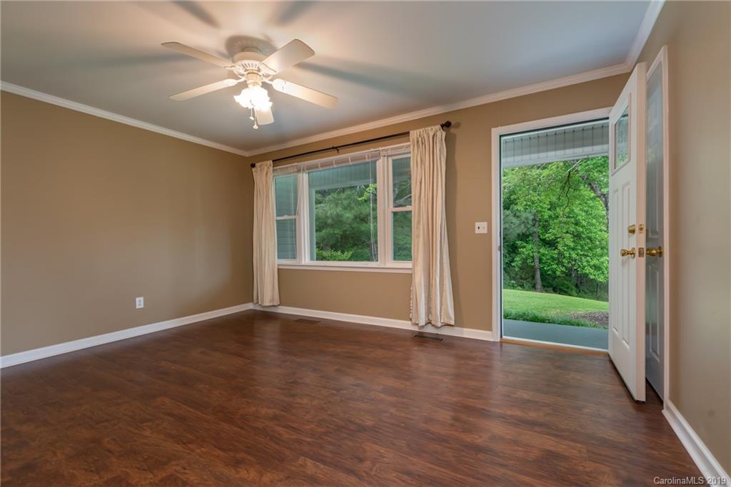 2760 Maple Creek Road Rutherfordton, NC 28139 - Photo 5 of 26 a view of an empty room with wooden floor and a window