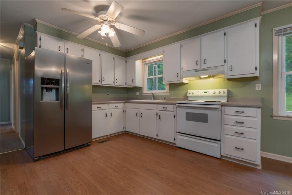 2760 Maple Creek Road Rutherfordton, NC 28139 - Photo 7 of 26 a kitchen with cabinets stainless steel appliances and a window