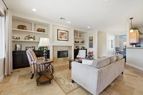 a living room with furniture and a fireplace