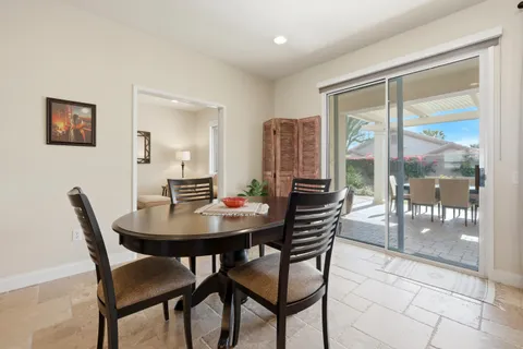 a view of a dining room with furniture and a potted plant